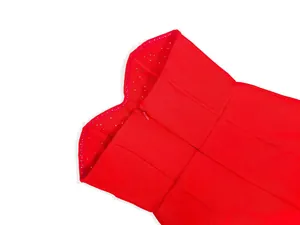 Close-up detail of a red sweetheart neckline bandage dress with delicate bead decorations