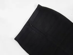 Macro detail of black bandage bodycon skirt showing high-quality ribbed texture and zipper.