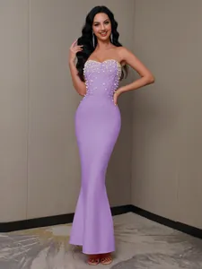 Detail view of pearl-embellished bodice on a purple strapless mermaid bandage dress.