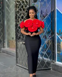 Close-up of elegant black bandage dress with large 3D red floral decorations on top