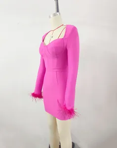 Side detail view of pink square neck bandage dress with feather cuffs on mannequin