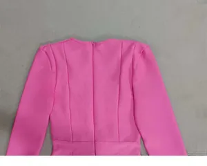 Close-up of the structured back seams and hidden zipper on a pink Hepburn style bandage dress