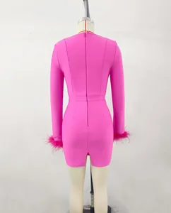 Detail view from behind of a pink long sleeve bandage dress with ostrich feather cuffs