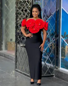 Elegant black bandage maxi dress featuring oversized red rosette floral shoulder details.