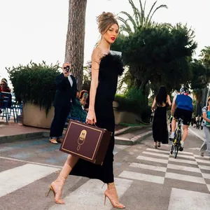 Elegant black bandage evening gown with ostrich feather trim for women, street style.