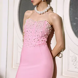 Elegant detail view of a pink strapless bandage dress with luxury pearl bead decorations