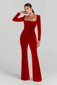 Close-up view of red velvet flared jumpsuit with sparkling rhinestone square neckline.