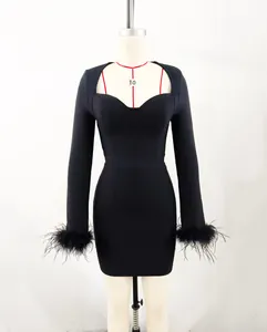 Elegant black bandage dress featuring long sleeves with luxury ostrich feather cuffs.