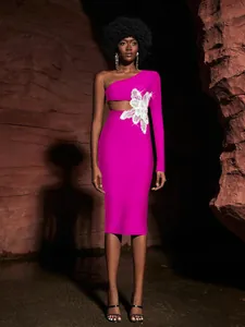 Detail view of pink one-shoulder bandage dress with sparkling flower waist cutout