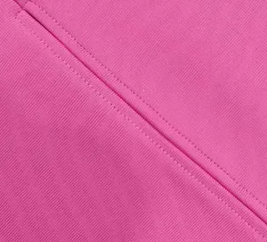 Close-up macro view of premium pink bandage dress fabric texture and fine stitching