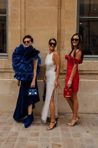 Elegant red off-the-shoulder rose detailed bandage dress shown in street style.