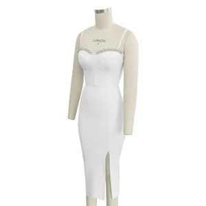 Detailed view of white bandage dress with sparkling rhinestone trim and front slit