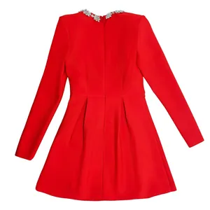 Back view of a red long-sleeved dress featuring rhinestone neckline and pleated skirt