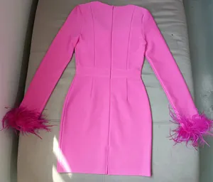 Full back view of a fuchsia pink bandage dress with elegant ostrich feather cuffs