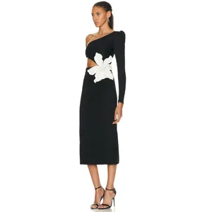 Detail of elegant black one-shoulder bandage dress with 3D white flower and waist cutout