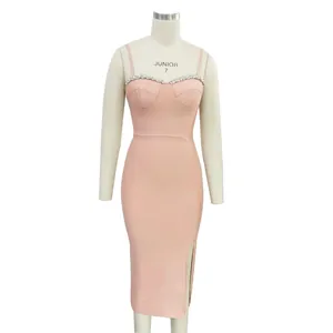 Detail view of pink bandage dress with rhinestone trim and side slit