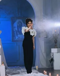 Elegant French style black and white evening gown featuring bold floral shoulder details