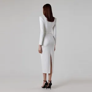 Elegant white long sleeve midi dress with structured horn shoulders and back slit detail