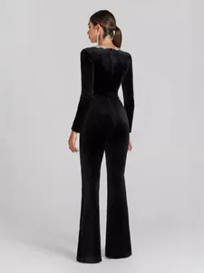 Elegant black long sleeve velvet jumpsuit with flared legs and rhinestone collar detailing
