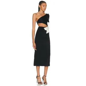 Side view of a one-shoulder black midi dress with waist cut-out and white floral detail