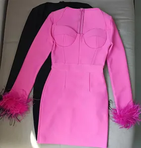 Macro detail view of a vibrant hot pink long sleeve bandage dress with ostrich feather cuffs
