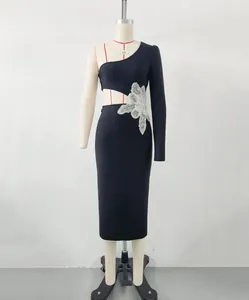 Detail view of one-shoulder bandage dress with sparkling flower applique and waist cutout