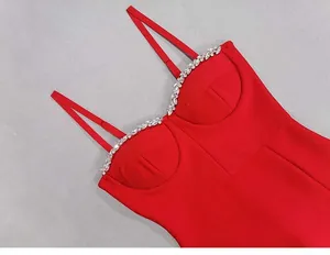 Close-up detail of red bandage dress with sparkling crystal rhinestones on neckline
