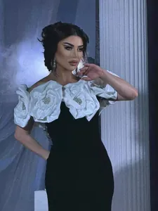 Elegant black bandage evening dress with white 3D floral bust and crystal accents.