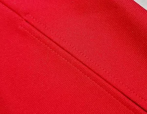 Macro close-up detail of red bandage dress fabric showing high-quality stitching texture