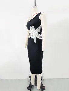 Black one-shoulder bandage midi dress with large white sequined floral detail on waist.