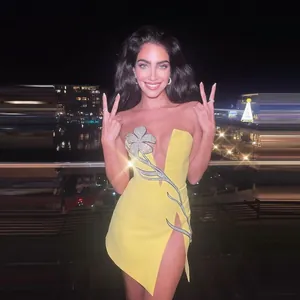 Elegant yellow strapless mini dress featuring a large rhinestone flower and sexy high slit
