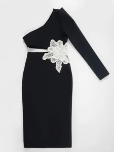 Detailed view of black one-shoulder bandage dress with waist cut-out and floral lace