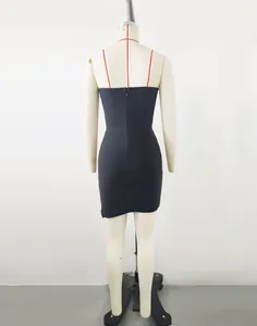 Close-up back view of a sleek black strapless mini dress with a central zipper detail