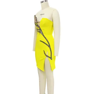Side view detail of yellow tube top dress featuring mesh flower and rhinestone slit decoration