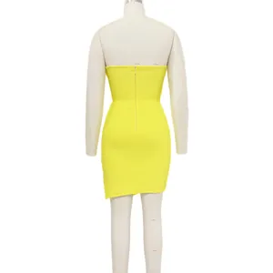 Detail shot of the back of a vibrant yellow strapless tube dress featuring a zipper closure