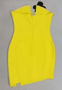 Detailed back view of a yellow strapless bodycon dress featuring flower detail and slit