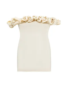 Detail view of 3D rose floral trim on an elegant cream off-the-shoulder bandage mini dress