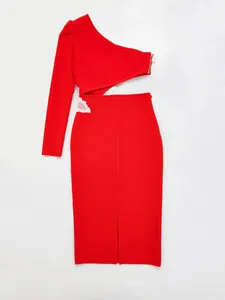 Detailed view of red one-shoulder bandage dress with waist cutout and white lace decoration.