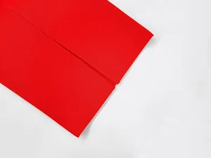 Macro view of the bright red bandage dress showing ribbed texture and slit detail