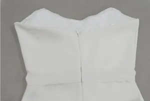 Detailweergave van de onzichtbare rits en taille van een witte Franse avondjurk voor dames