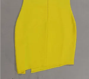 Close-up of asymmetrical slit hem on bright yellow mesh flower evening dress.
