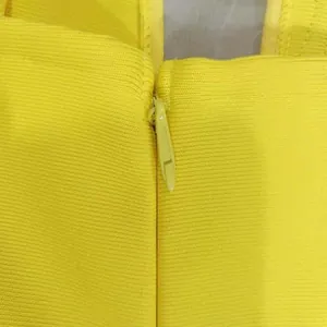 Close-up detail showing the hidden back zipper of this elegant yellow strapless gown