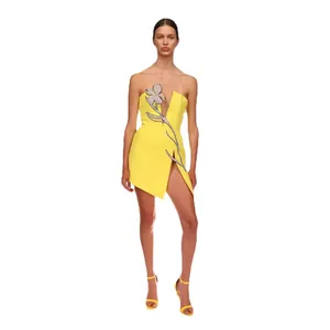 Yellow strapless mini dress with rhinestone flower and thigh-high split detail