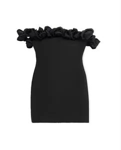 Close-up of elegant black off-shoulder bandage dress with 3D floral neckline detail