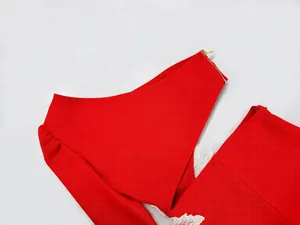 Close-up view of red one-shoulder bandage dress with cutout waist and floral lace