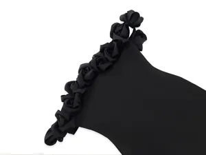 Close-up of 3D rose floral detailing on black off-shoulder bandage dress neckline