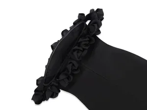 Close-up of black off-the-shoulder dress with 3D floral ruffles