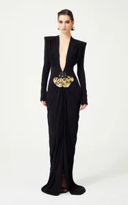 Elegant black floor-length gown with deep V-neck and ornate insect embellishment