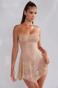 Detailed view of nude sheer mini dress with sparkling rhinestone embellishments