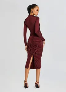 Back detail of a burgundy ruched midi dress featuring sparkling rhinestones and a stylish slit